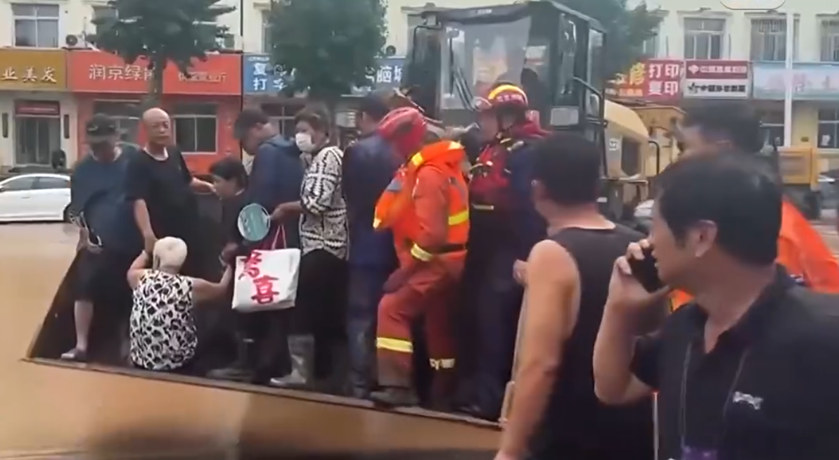北京市密雲區成為此次洪水受災最嚴重地區，熱心居民組成救援小組，以鏟車救出許多受困民眾。 圖：擷取自網路影片