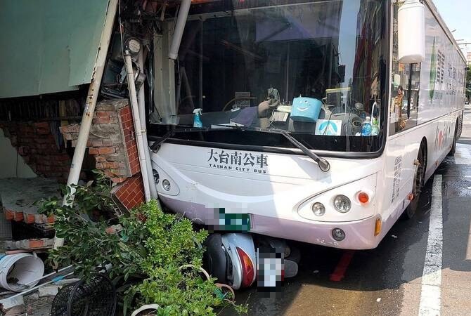 台南一輛公車突然因不明原因往前滑行，撞進一旁路邊民宅。 圖：民眾提供