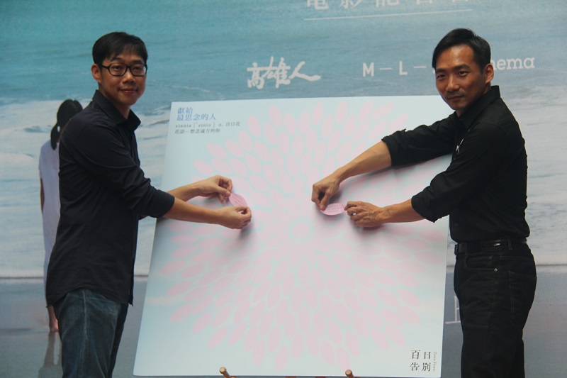 《百日告別》導演林書宇(左)在「百日花」裝置藝術上貼上第一朵留言花瓣，象徵獻給高雄最美麗的花朵，表現高雄支持生命關懷的精神，希望民眾一同留言分享愛與失去的故事。圖：高雄市文化局提供
