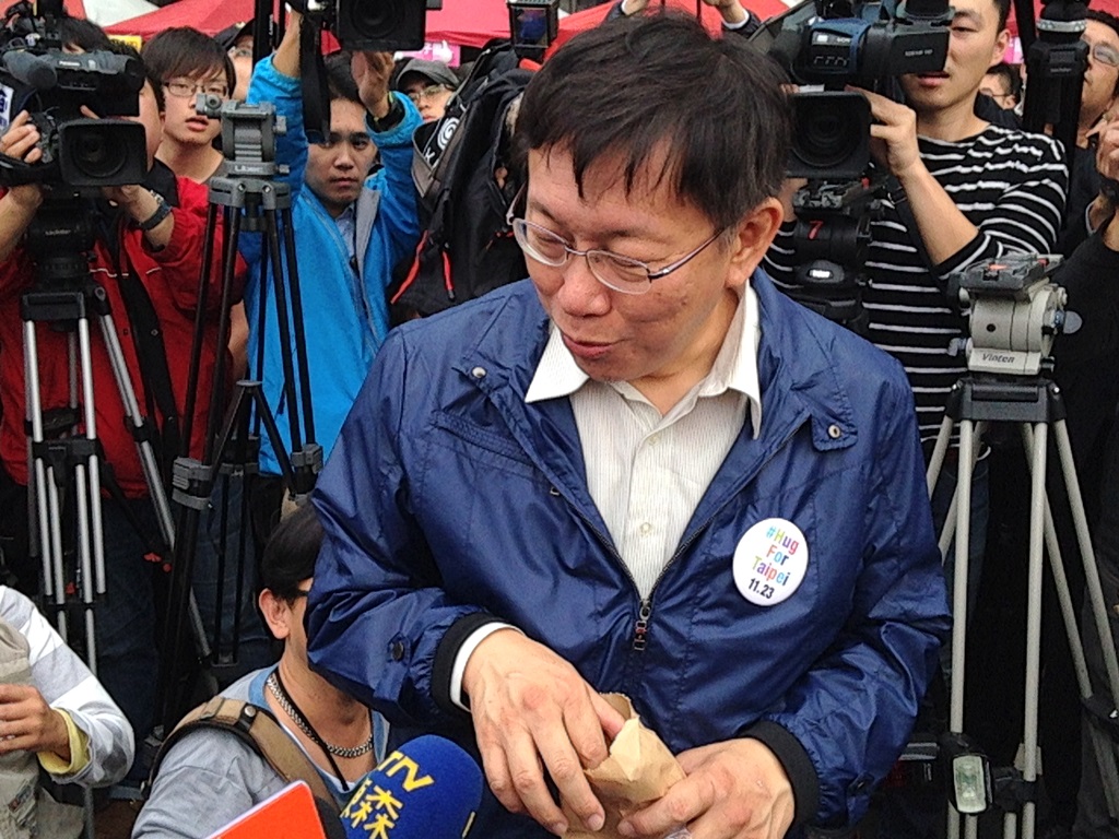 無黨籍台北市長候選人柯文哲今(15)日下午拿著地瓜媽媽給的地瓜，不過當媒體希望柯文哲當面把地瓜吃掉時，柯文哲說「不要故意那個…帶回去偷吃就好！」圖2之1：劉奕霆/攝。