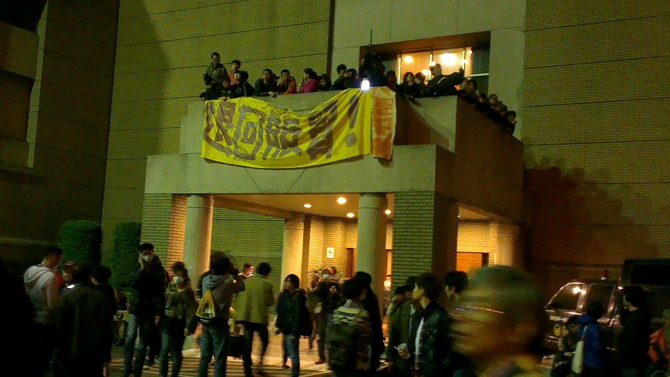 台北夜未眠！反服貿學生23日晚間7點半占領行政院，在政院辦公室前掛出反服貿的布條。圖：莊豐嘉/攝