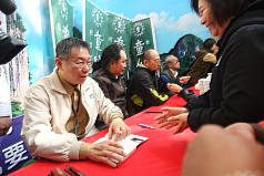 台大醫師柯文哲（左）5日在台北市出席簽書會，為支持者簽名留念。圖:中央社
