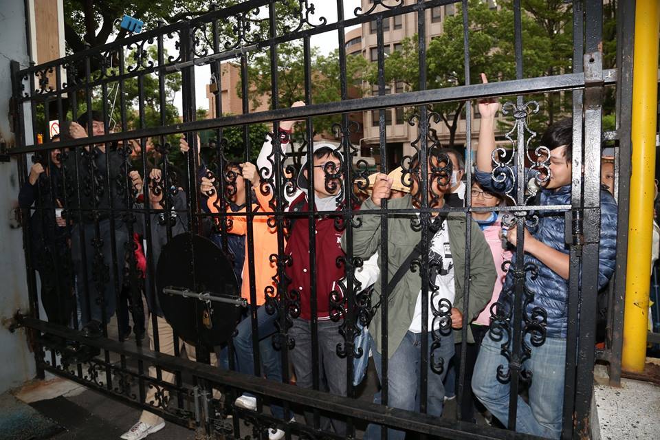 立法院濟南路門口外，陳為廷（右一）等人做勢攀牆抗議，怒喊「張慶忠！」。圖：林雨佑/攝
