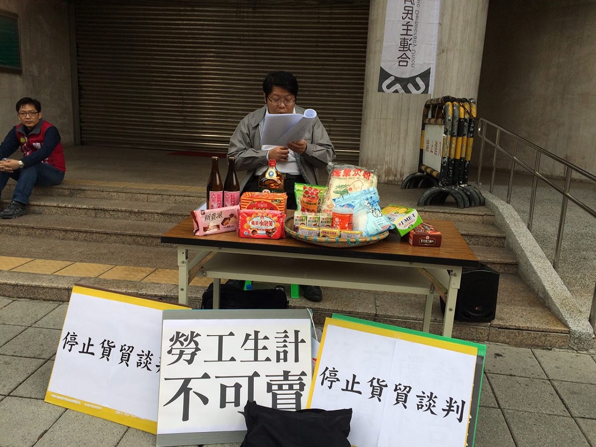 為了反對貨貿協議簽訂，經濟民主連合召集人賴中強26日在立法院前逐一宣讀貨貿將開放的1050項中國工業貨品。圖：楊淳卉/攝