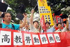 高教工會30日在五一勞動節前夕到教育部門口，舉著學士帽，高喊「反對校園血汗工廠」、「反對高教勞動非典化」、「要保障工作權，重建高教勞動基準」等口號，並要求教育部進行校園勞動全面檢查。圖片來源:中央社