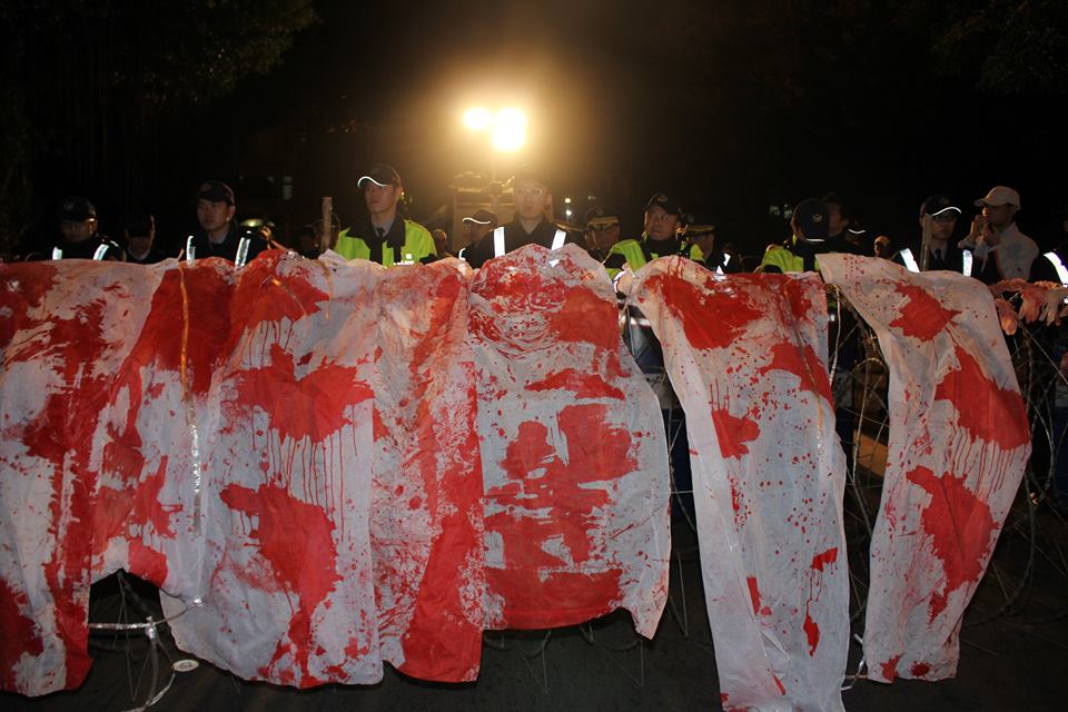 消防員在總統官邸前的蛇籠上掛上19條血衣，象徵這2年殉職的消防弟兄。圖2之1：林雨佑/攝