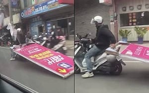 中壢阿北單手騎車「耍特技」！拖行巨大看板   警：最高可罰18000元
