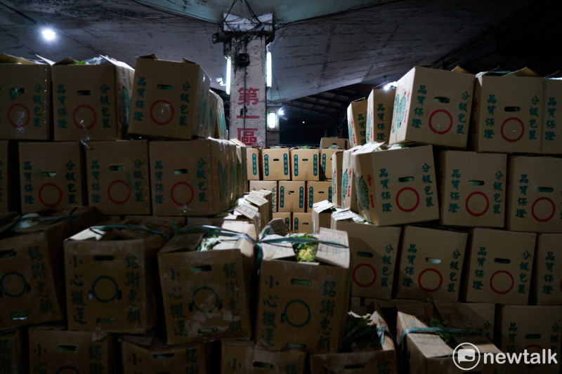 台北農產公司第一果菜市場內等待拍賣的蔬果堆得像山一樣高。   圖：張良一/ 攝