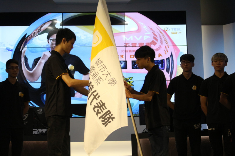 隊長洪勝郁將隊旗授予學弟，象徵傳承意味。