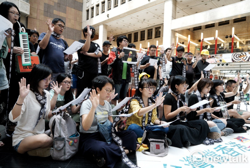 多位支持香港「五大訴求 缺一不可」的台港民眾今天中午在台北火車站中庭呼喊支持香港的口號，並高唱「願榮光歸香港」歌曲。   圖：張良一/攝