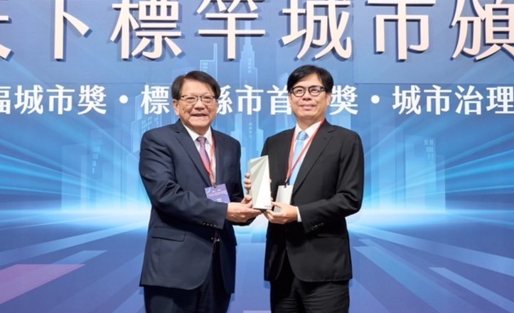 陳其邁(右)自總統府秘書長潘孟安(左)手中接下「永續幸福城市獎」獎座。   圖:高雄市政府/提供