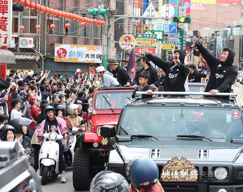 中華職棒樂天桃猿封王遊行2日下午登場，路線從樂天桃園棒球場出發，一路至桃園市政府廣場，球員林泓育（車上右起）、林立向球迷揮手致意，一同歡慶奪冠喜悅。中央社記者張新偉攝　114年11月2日   