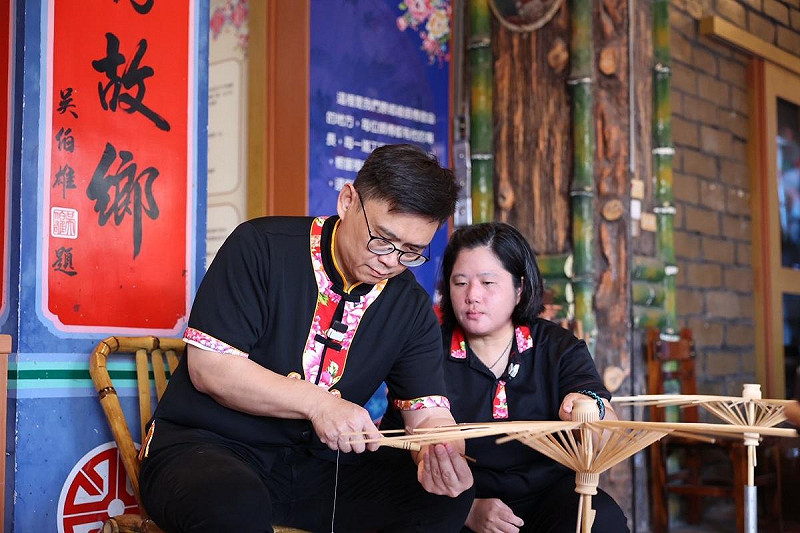賴瑞隆(左)走訪客庄親手體驗油紙傘製作。   圖：賴瑞隆辦公室/提供