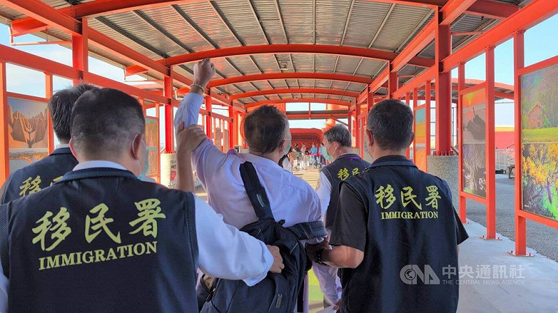 盧姓中國籍男子（舉手者）6日在金門縣政府前拋撒寫有「統一台灣」等字句傳單，遭強制驅逐出境。移民署人員將盧男帶往小三通碼頭途中，他還數度高喊「兩岸和平統一」、「打倒台獨」等語。中央社記者吳玟嶸攝　114年11月6日   