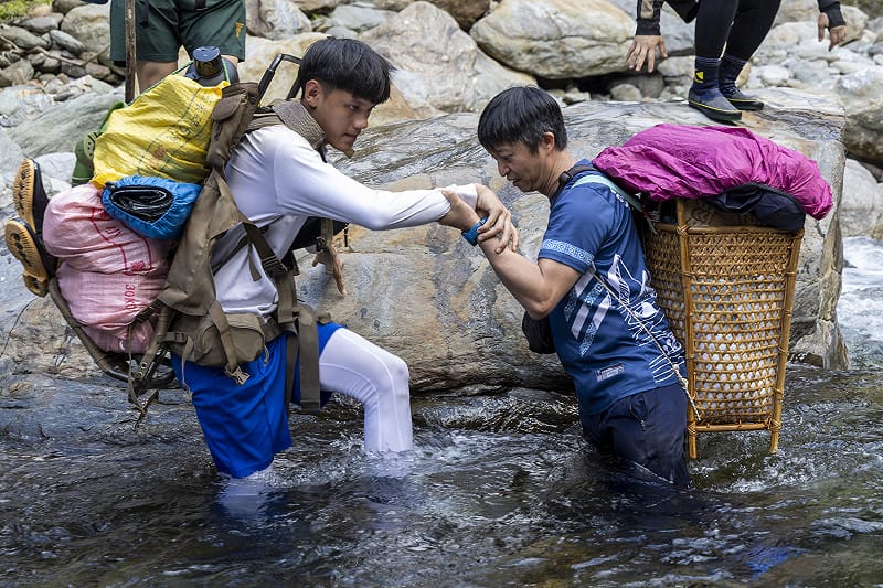 武塔國小師生返回舊部落，校長楊偉琳（右）背著泰雅藤籃kili參與活動。武塔國小為民族實驗小學，現有文化課程涵蓋織布、傳統工藝、族語與文學、家庭文化及社會組織與部落史地等主題，老師與耆老帶領學童返回舊部落，探尋祖先生活環境與歷史。&nbsp;&nbsp;&nbsp;武塔國小提供/黃子明攝影