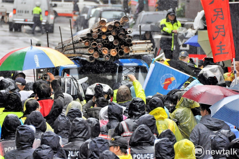 勞團載來竹子準備搭棚躲雨.遭警方阻擋，雙方爆發第三度衝突。   圖：陳香蘭/攝