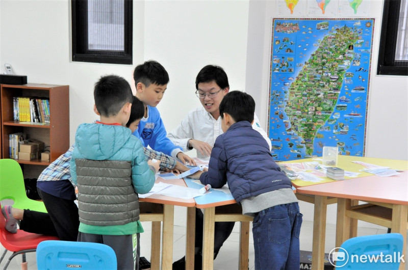 數學老師李世韡（右2)帶著四個小朋友，玩著遊戲；他透過遊戲的過程，觀察孩子們遇到問題時，是用什麼方式在理解，又用什麼方式解決？   圖:陳香蘭／攝