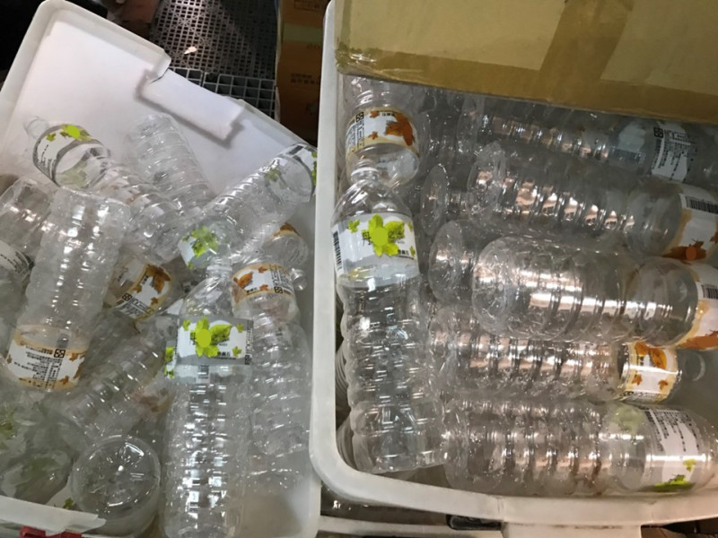 高雄市衛生局查獲醫名不法黑心廠商，利用回收的「丹楓之水」空寶特瓶裝自來水再賣給酒店、小吃店及餐館，10年來不法所得超過3百萬元。   圖：高雄市衛生局／提供