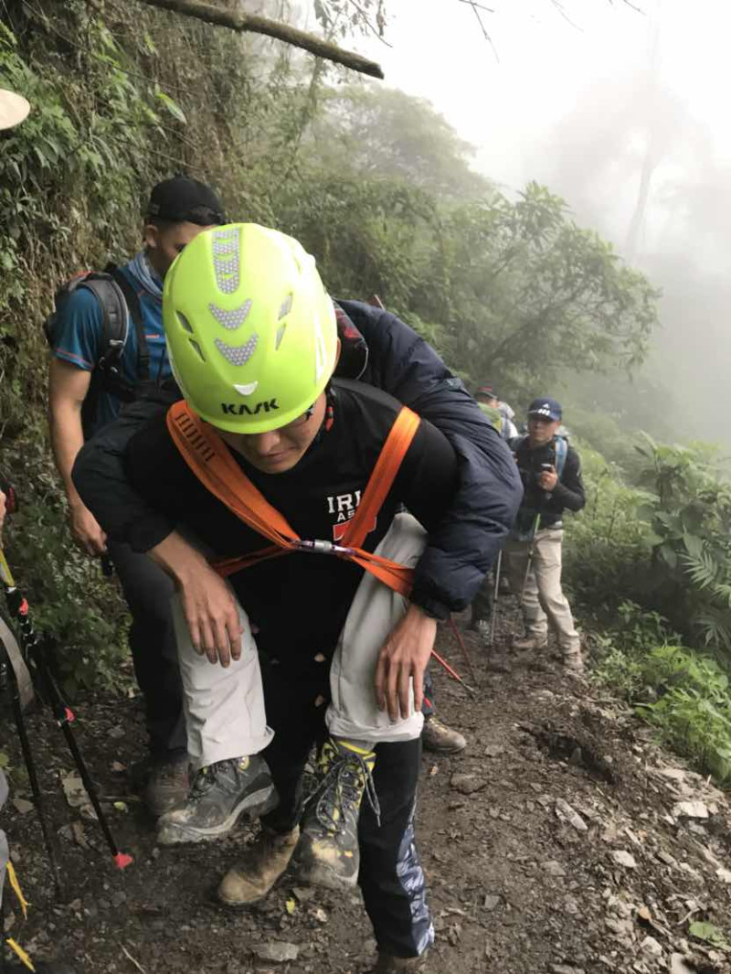 救援人員將受傷的登山客背負下山。   圖 : 屏東縣消防隊/提供
