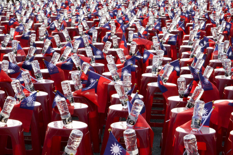 國民黨高雄市長候選人韓國瑜岡山造勢晚會現場的椅子上放置國旗和瓶裝水。   圖：張良一/攝