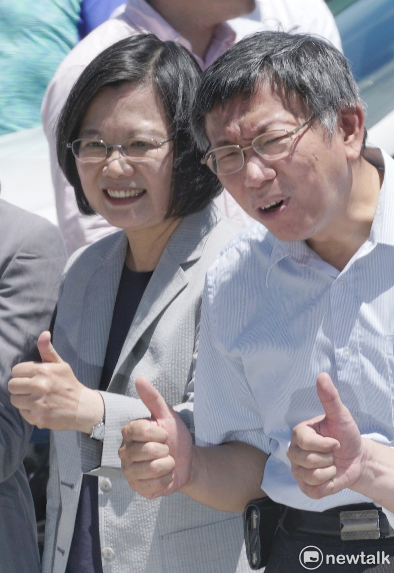 總統蔡英文、台北市長柯文哲一起參觀新車及多元計程車款式發表，合照時，柯文哲面對媒體頻頻追問是否要當面問蔡總統「台灣價值」時，露出尷尬的表情。   圖：張良一 / 攝