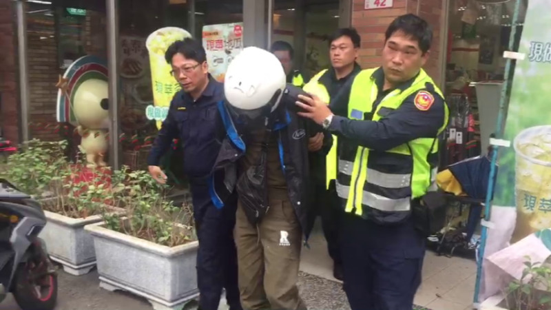 警方將持槍搶劫廖姓嫌犯上銬後帶回警局偵訊。   圖：林昀真／翻攝