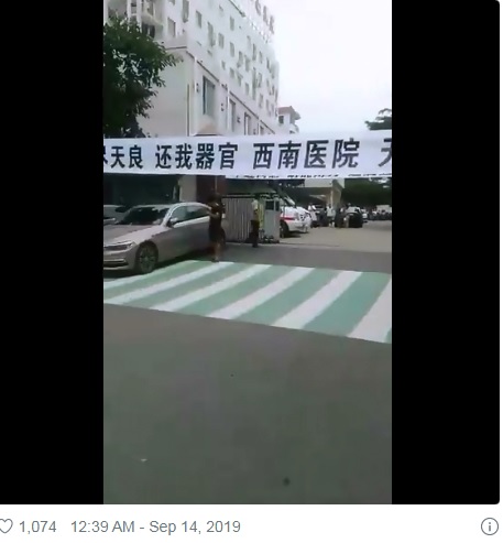 中國有軍方背景的重慶西南醫院，院外有民眾拉白布條高喊「還我器官」。   圖：翻攝自推特