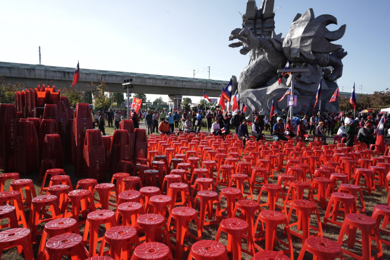 韓國瑜抵達造勢大會前，在現場後方仍堆疊為數眾多的椅子未拆開，擺好的椅子也未坐滿。   圖：張良一/攝