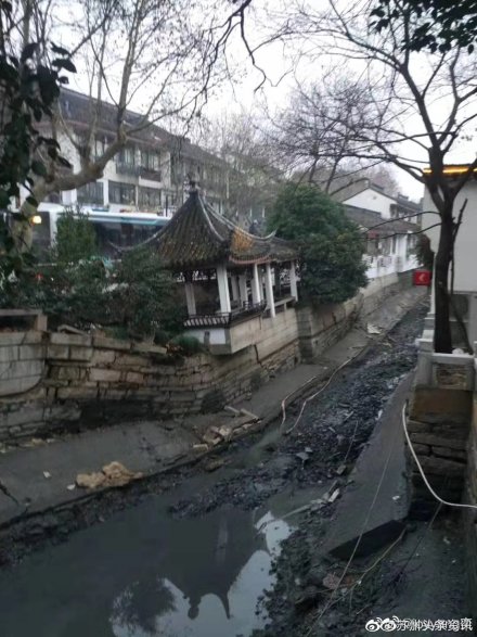 中國蘇州市著名的十全街蘇州飯店公車站前5日突然塌陷，整條街道看起來像黑色豆腐渣。   圖：翻攝自蘇州頭條資訊微博