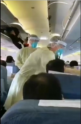 中國武漢爆發新型冠狀病毒感染的肺炎，有中國網民上傳在飛機上中國檢疫人員一一對旅客量體溫的影片，顯示疫情嚴重。   圖：翻攝自楠源卍奇說推特