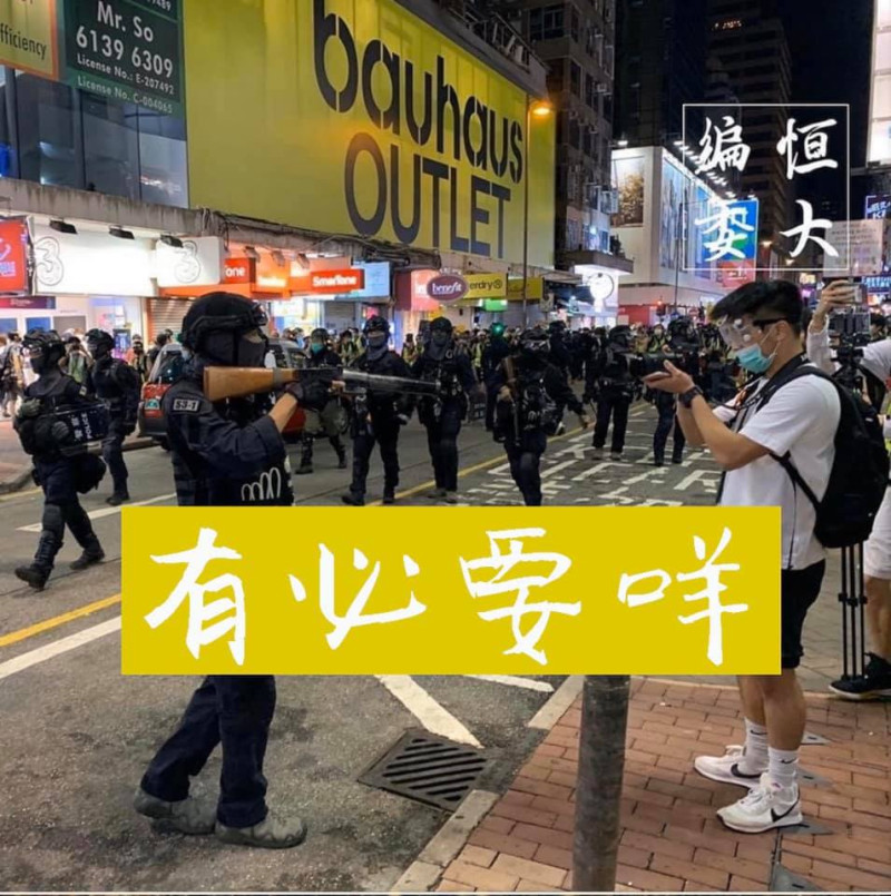 香港「和你唱」活動爆發警民衝突，1名警察拿著槍對準手持攝影機的年輕人，再度引發黑警暴力疑慮。   圖：翻攝自Umbrella City Cyberchurch臉書/香港恒生大學學生會編委