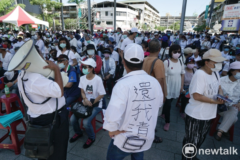 一位韓粉的背後寫著「還我清白」並要群眾高喊：「韓國瑜加油」口號。   圖：張良一/攝