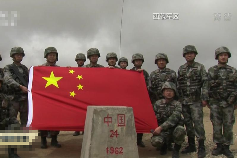 西藏軍區一名中將帶隊巡邏邊境，用紅漆將邊境的界碑刻字重新描紅，並在界碑旁展示紅旗宣示主權。   圖:翻攝自央視直播