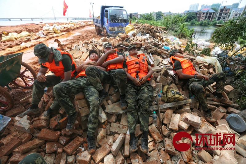 長江水患告急，加入抗洪工作的武警，累得在江邊倒頭就睡。   圖 : 翻攝自環球網