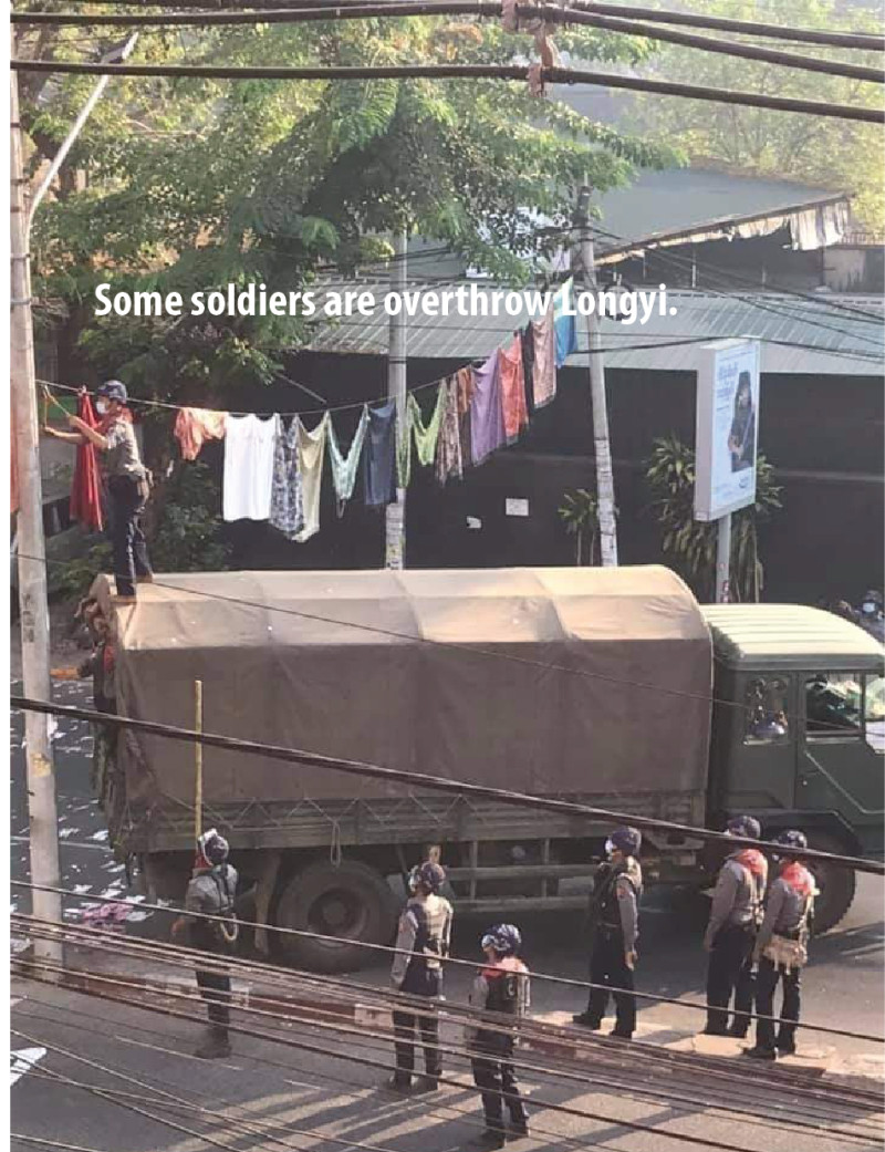 社群網站張貼的影片可見，緬甸警察會把晾掛的成列衣服拿開，再走過街道。   圖/翻攝自推特