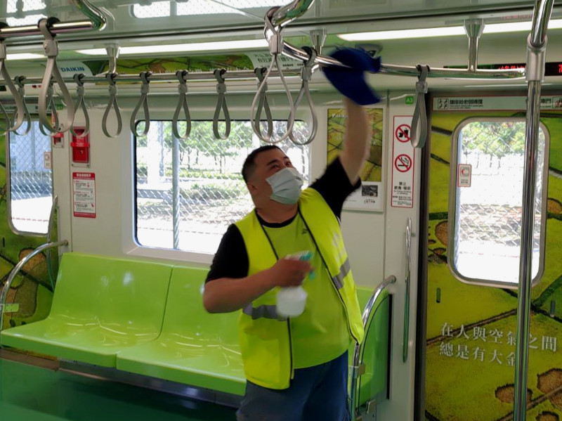 清潔人員消毒捷運車廂內的扶手、拉環。   中捷/提供