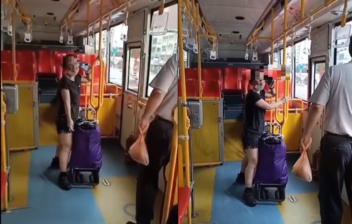 台中市一名婦人拖著行李搭乘公車，但在車上卻將口罩拉到下巴。   圖:記者爆料網提供