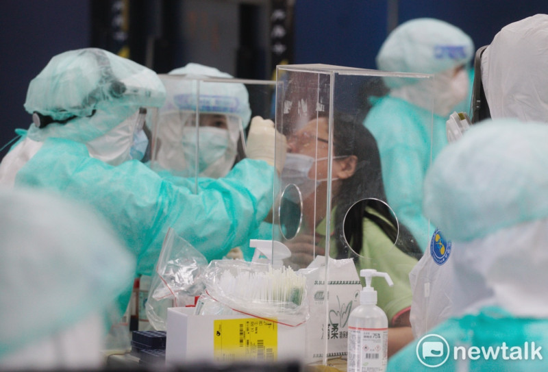 北榮今日出動80名醫護進駐台北濱江果菜市場執行採檢任務(圖為北農員工以及市場人員PCR檢測照)。   圖：張良一/攝