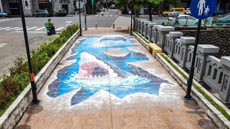 台中人行橋上的3d彩繪，以大口鯊魚衝出水面製造刺激緊張的氛圍。   圖：台中建設局／提供