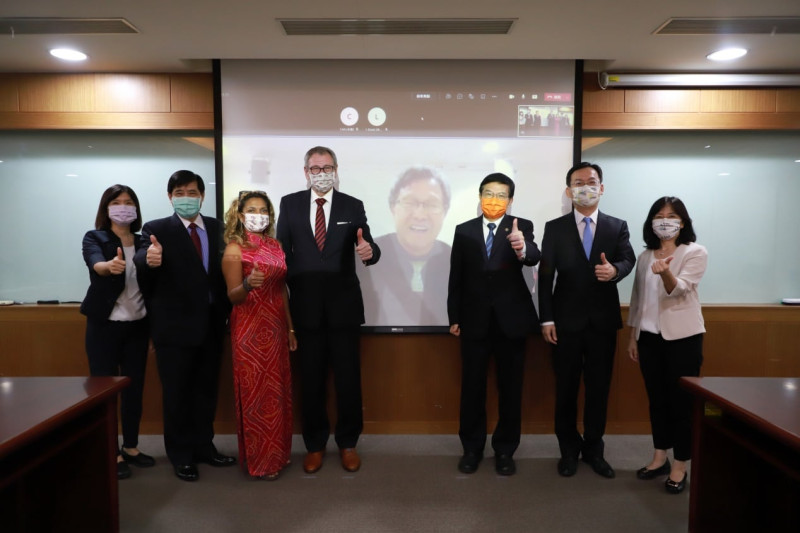 台灣駐德代表處大使謝志偉（中，影像）與德國駐台代表王子陶（左四）透過視訊，完成新版協議簽署，我交通部長王國材（右三）現場見證。   圖：翻攝自駐德代表處臉書