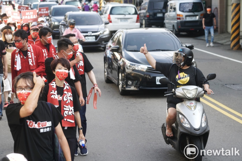 一位機車騎士比出大姆指手勢向陳柏惟表達支持之意。   圖：張良一/攝