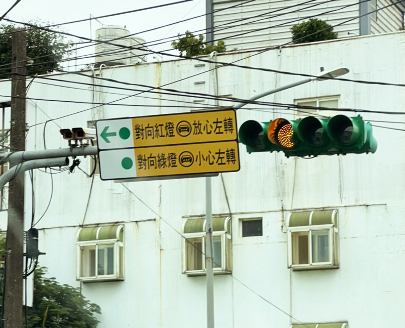 中央大學前的交通標誌寫著「對向紅燈放心左轉、對向綠燈小心左轉」，讓不少用路人搞不清楚「到底何時才能左轉？」   圖：謝美英／提供