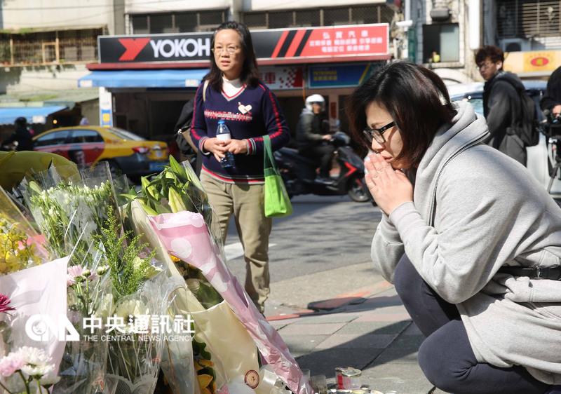 台北市4歲女童28日在內湖地區遭斷頭殺害，29日有不 少民眾回到案發現場，獻上鮮花、卡片、布偶，並雙手 合十，願女童一路好走。    圖：中央社
