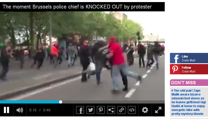 比利時布魯塞爾24日勞工抗議遊行，當地1名警察局長（右二）遭到紅衣男子從背後攻擊頭部，當場倒地不起。   圖：翻攝《每日郵報》