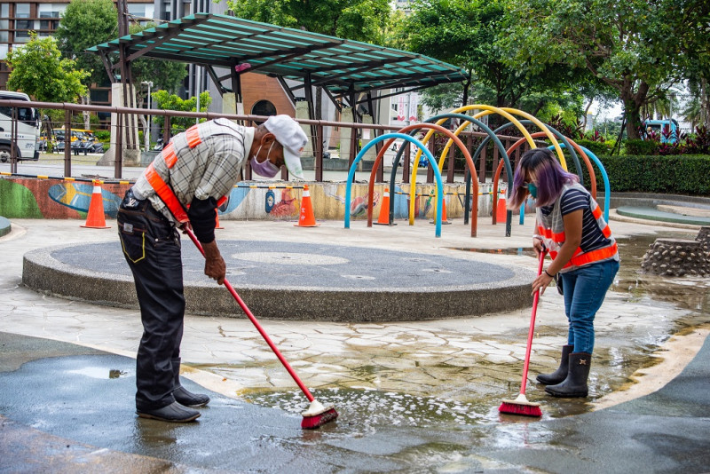 清潔人員刷洗戲水池地面。   圖：新北市水利局提供