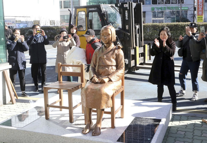 韓國民間團體去年12月於釜山日本領事館前，放置象徵受害慰安婦的「和平少女像」。為此，日本召回駐韓大使表達抗議。    圖：達志影像/美聯社資料照片。