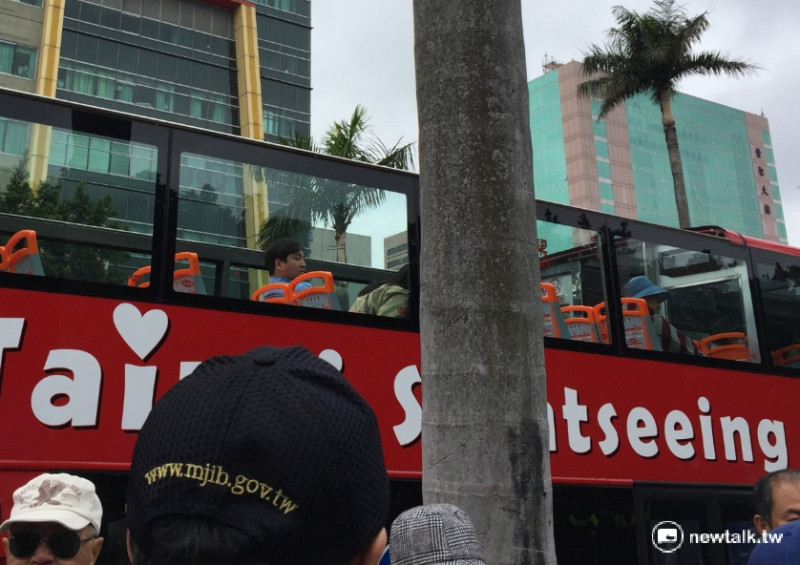 「800壯士」反年改抗爭活動人聲鼎沸，也吸引搭乘雙層觀光巴士的外國旅客側目。   圖：柯昱安/攝