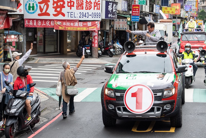 沿途市民熱烈歡迎，揮舞「新北大翻新」手搖旗為車隊加油打氣，向車隊伸出大拇指比讚，表態支持1號市長候選人林佳龍。   圖：林競辦提供