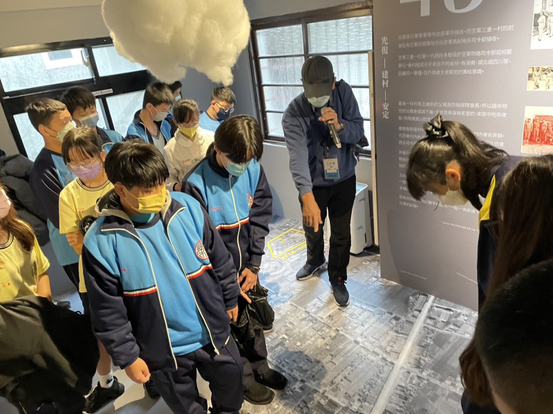 光榮國中師生聆聽「晴空下的守護者」特展導覽，認識三重地景變遷。   圖：新北市文化局提供