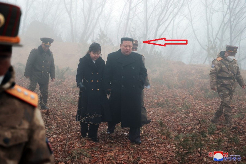 北韓官媒《朝中社》釋出19日進行所謂「核反擊假想綜合戰術訓練」照片，金正恩身邊出現一名戴口罩、墨鏡的男子。   圖：翻攝朝中社